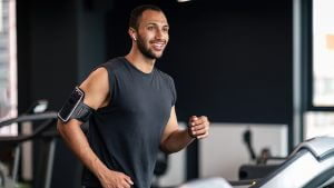 A healthy young man running in the gym.